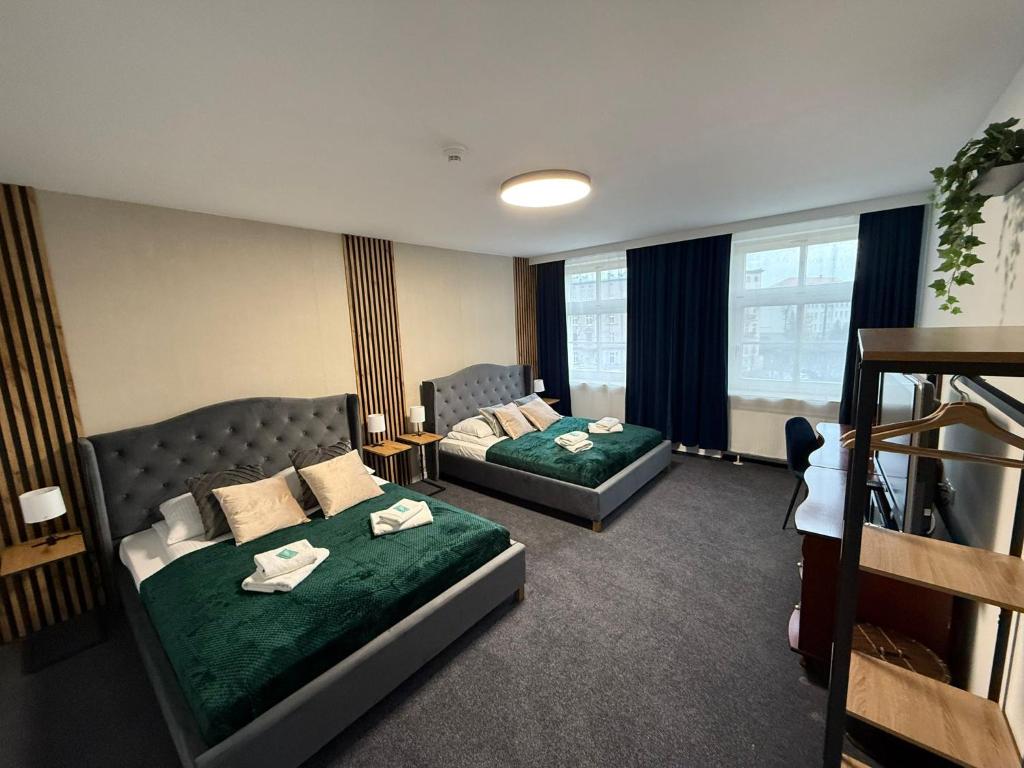 a hotel room with two beds and a couch at Great Polonia Wrocław Tumski in Wrocław