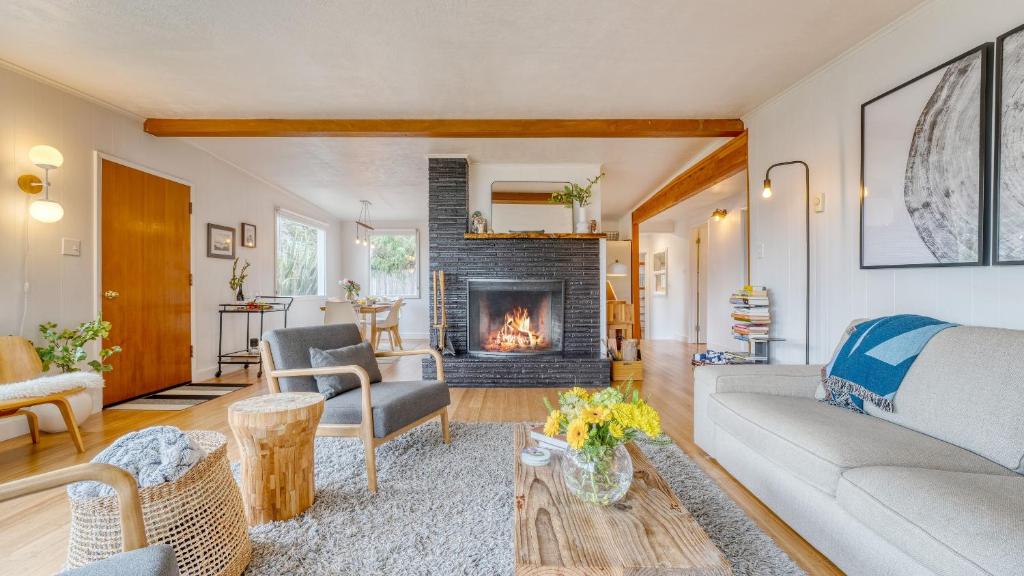 a living room with a couch and a fireplace at Four Bears by AvantStay Walk to Beach Hot Tub Ocean View in Arch Cape