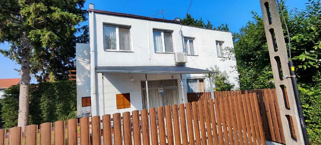a white house with a fence in front of it at unit_type_semidetached_house Siofok 54624 in Balatonszabadi Fürdőtelep