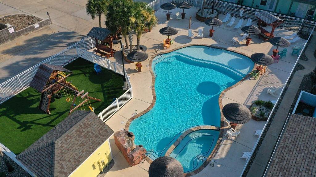 an overhead view of a swimming pool at a resort at Shared Resort-Style Pool Playground Patio w Bar Tidal Times by AvantStay in Port Aransas