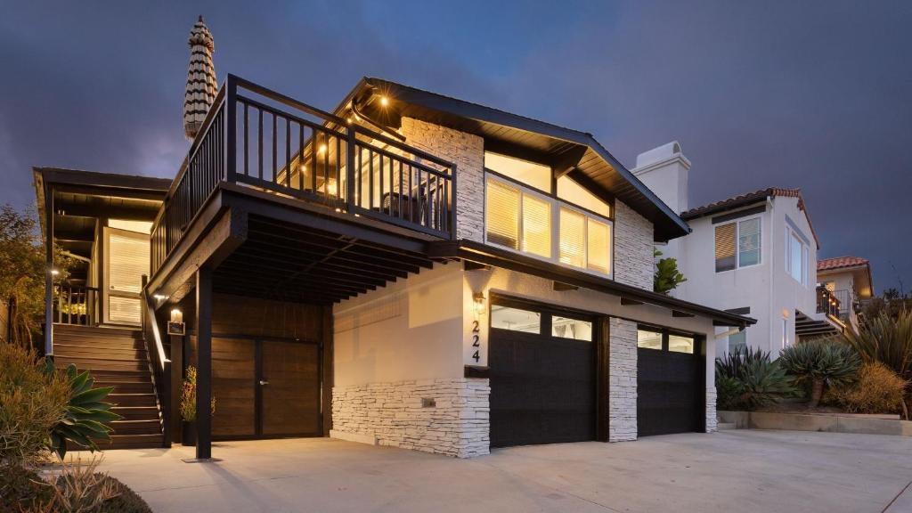 a large house with a balcony and a garage at Stone Lagoon by AvantStay Steps to the Beach Backyard Oasis in San Clemente