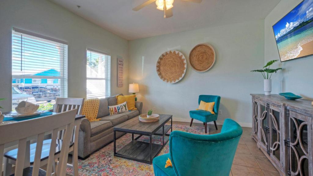 una sala de estar con un sofá y sillas en Chic 2BR Coastal Condo Shared Pool Near the Beach Costa Bahia 103, en Port Aransas