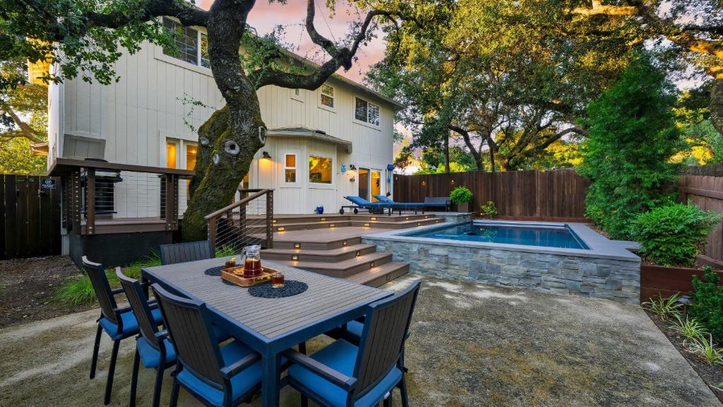 a patio with a table and chairs next to a pool at Casa Osito by AvantStay Pool Hot Tub Outdoor Dining Minutes from Sonoma Plaza in Sonoma