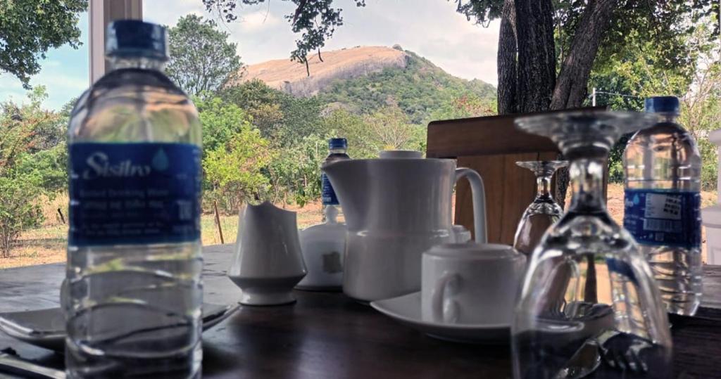 a bottle of water sitting on top of a wooden table at Sigiri Arana Sigiriya in Sigiriya
