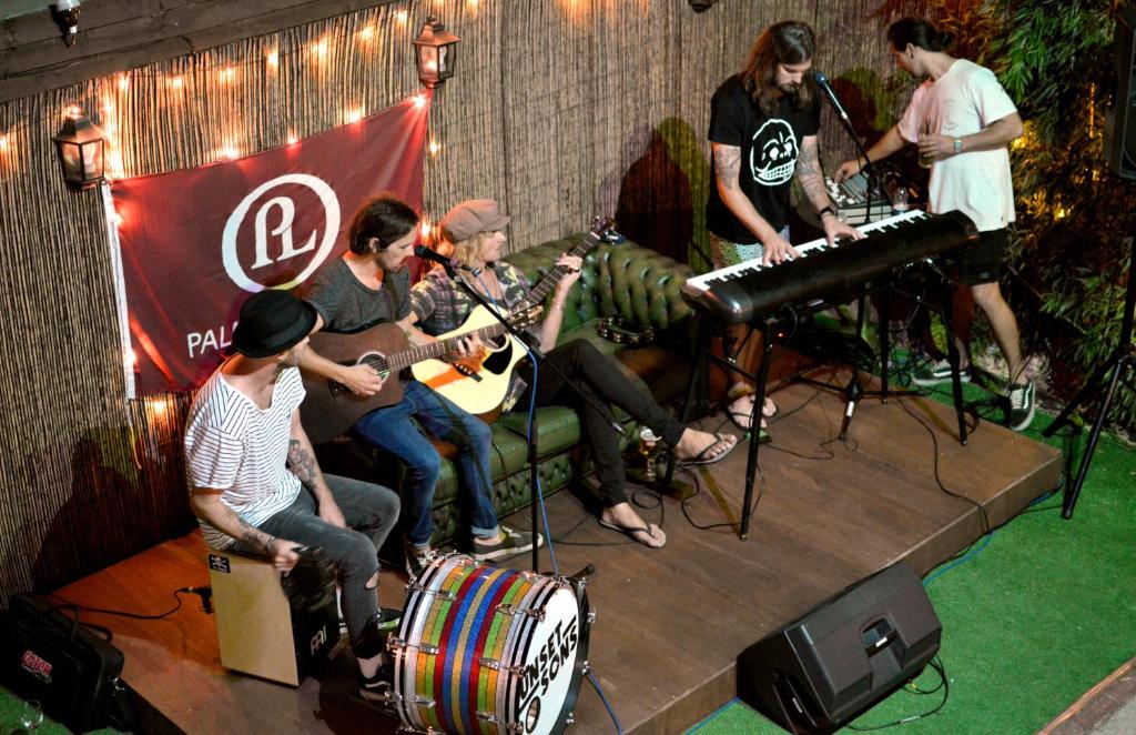 a group of people playing music on a stage at Palmers Lodge Swiss Cottage in London