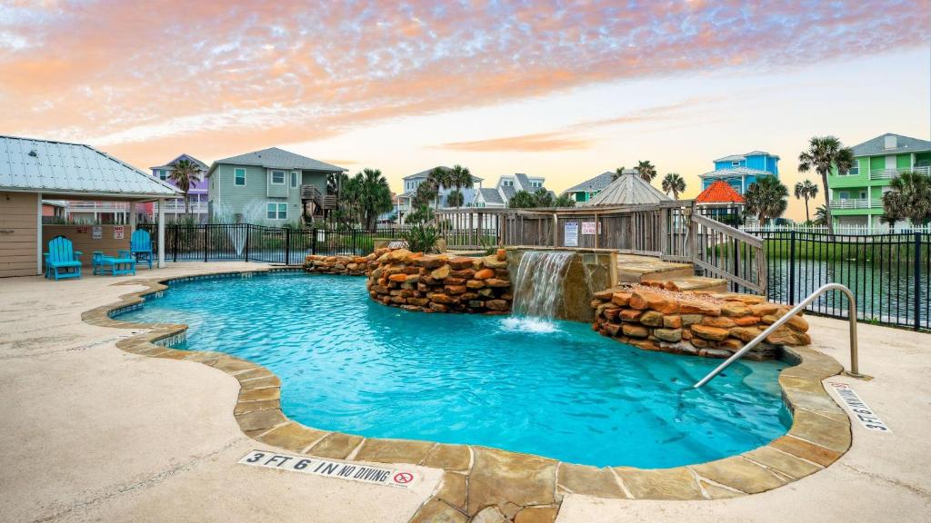 a pool with a waterfall and a water slide at La Concha Blvd 31 - in Padre Island