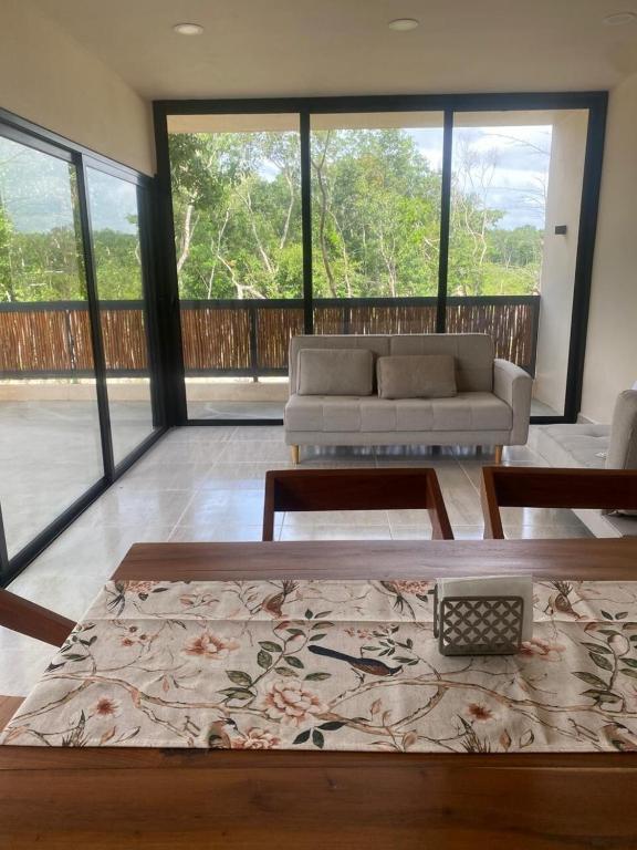 a living room with a couch and a table at The Empire in Tulum in Tulum