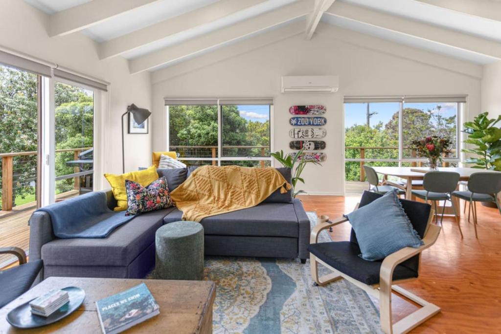 a living room with a couch and a table at The Balcony - pet friendly! in Torquay