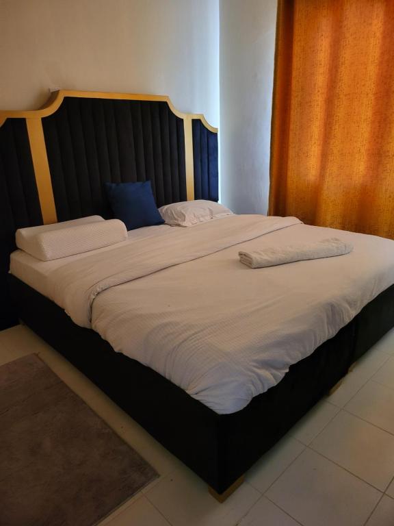 Кровать или кровати в номере GG PREMIUM Ngala 3br Five Beds