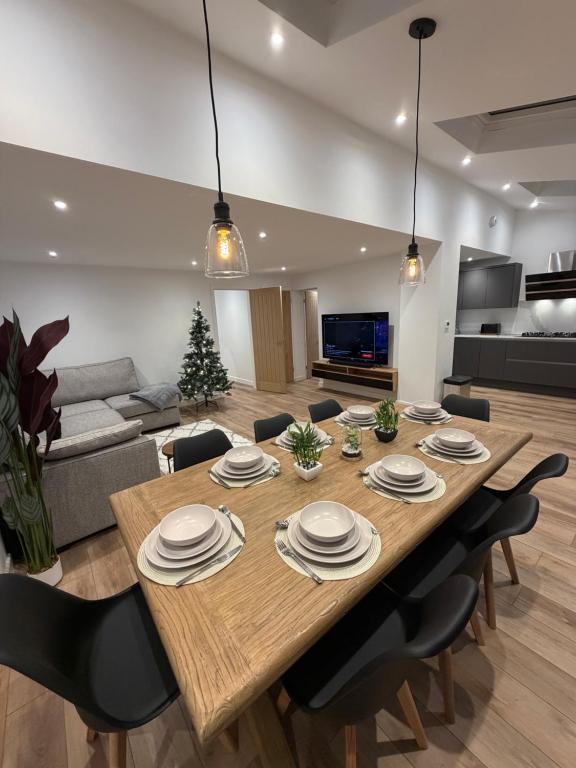 a living room with a large wooden table and chairs at Luxury House, Great Location in Redditch - Contractors - Families - Groups - Relocators - Sleeps 9 in Bentley