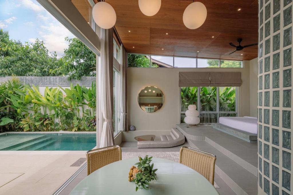 a villa with a pool and a bedroom at The Outside Design Suites in Uluwatu