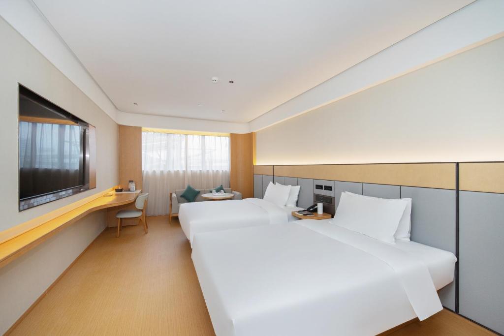 Ένα ή περισσότερα κρεβάτια σε δωμάτιο στο JI Hotel Nanjing Jiangning Jiaotong University Subway Station