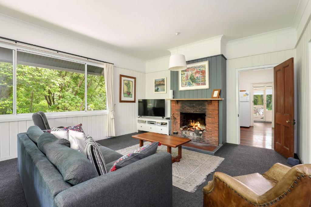 a living room with a couch and a fireplace at Finchley in Blackheath