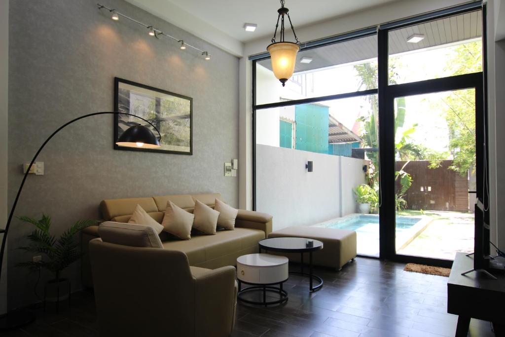 a living room with a couch and a table at Tehya Villa in Da Nang