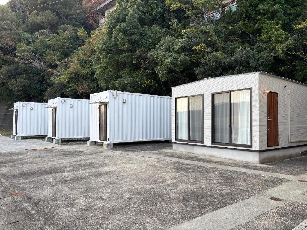 a row of white buildings in a parking lot at Yura terrace in Yura