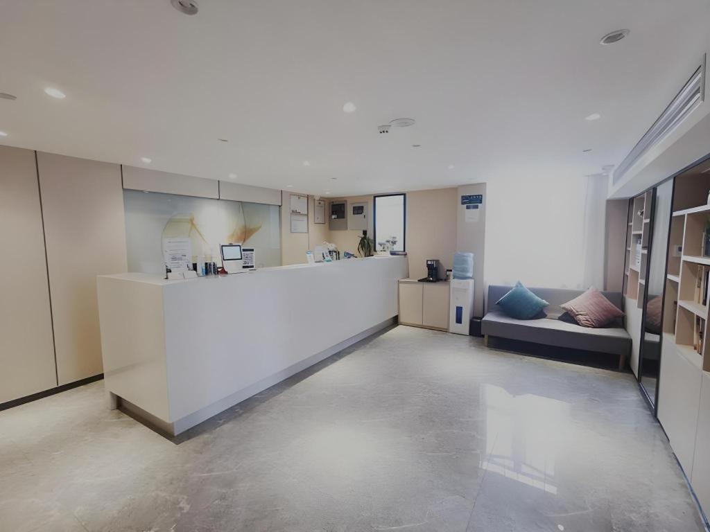 a large white room with a counter and a kitchen at Green Tree Inn Express Shanghai Bund Yuyuan Xiaonanmen Metro Station in Shanghai