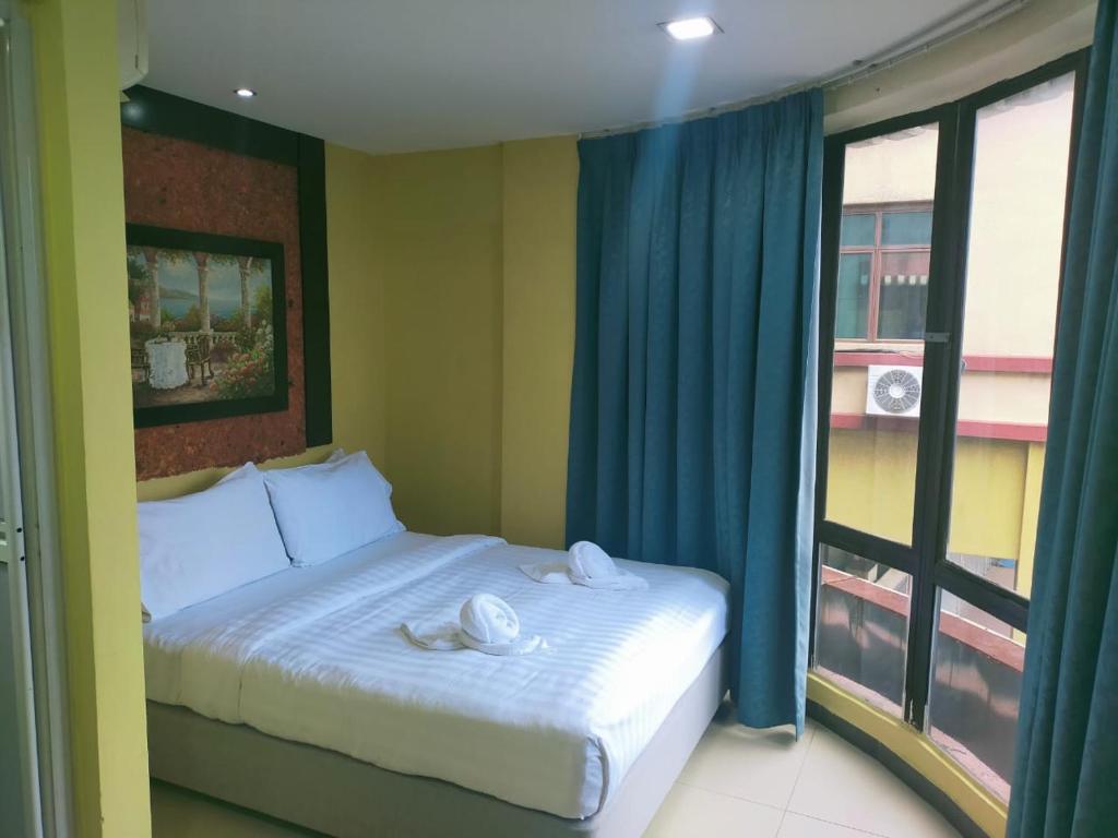 a bedroom with a bed with towels on it at Swing & Pillows - Sentul in Kuala Lumpur