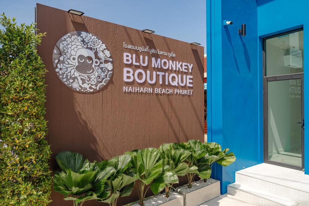 a sign for a blue monkey bouquet outside a building at Blu Monkey Boutique Naiharn Beach in Nai Harn Beach