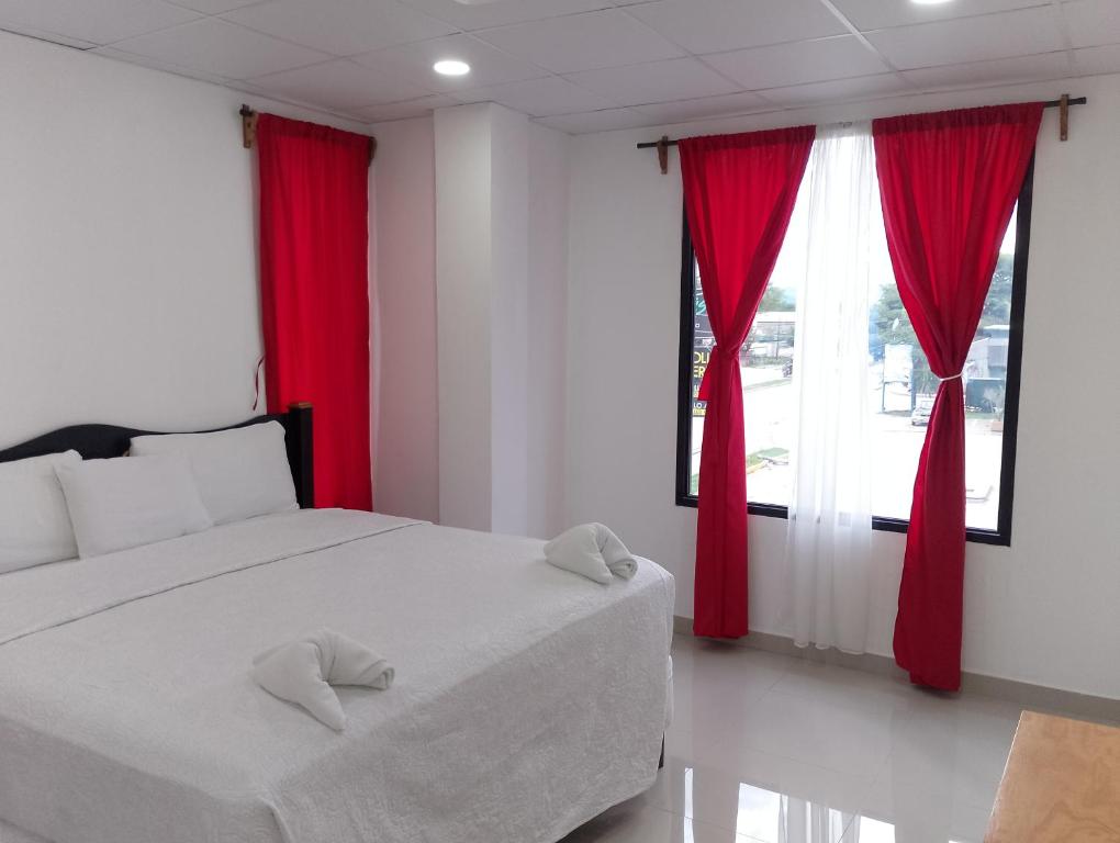 Ένα ή περισσότερα κρεβάτια σε δωμάτιο στο Hotel Mendoza Inn