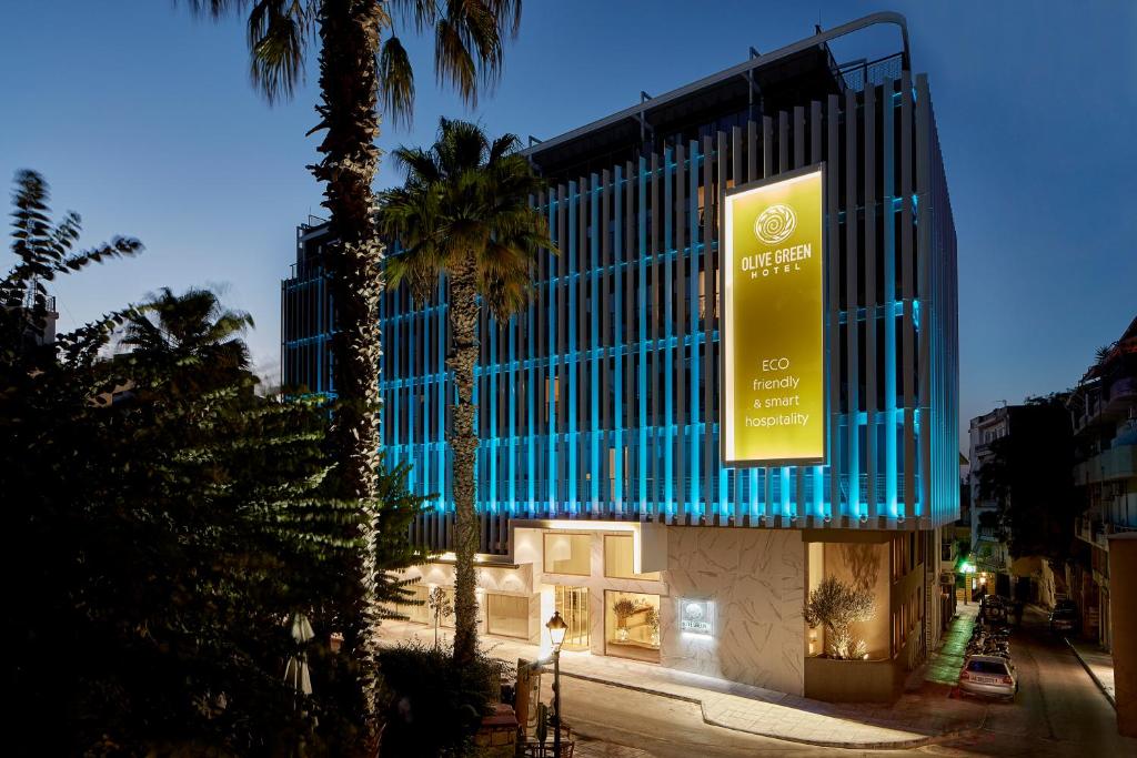 a building with a large sign on the side of it at Olive Green Hotel in Heraklio Town