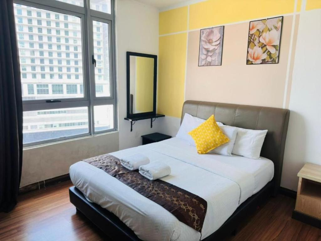 a bedroom with a bed and a large window at Taragon Puteri Bintang KLCC View Studio Apartment in Kuala Lumpur