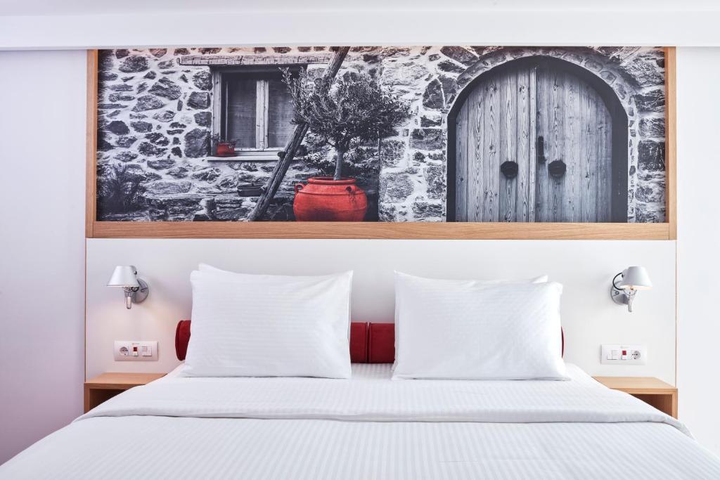Postel nebo postele na pokoji v ubytování Olive Green Hotel