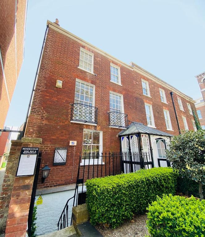 a large red brick building with a black gate at Grade II listed 3 bed townhouse in Exeter, Devon in Exeter