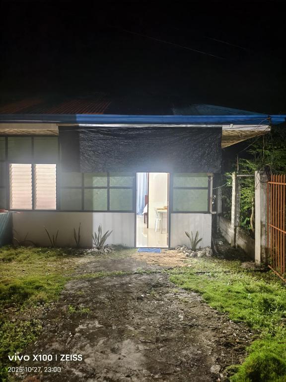 a house with a white door at night at Reefside Retreat by B'lu Bamboo in Moalboal