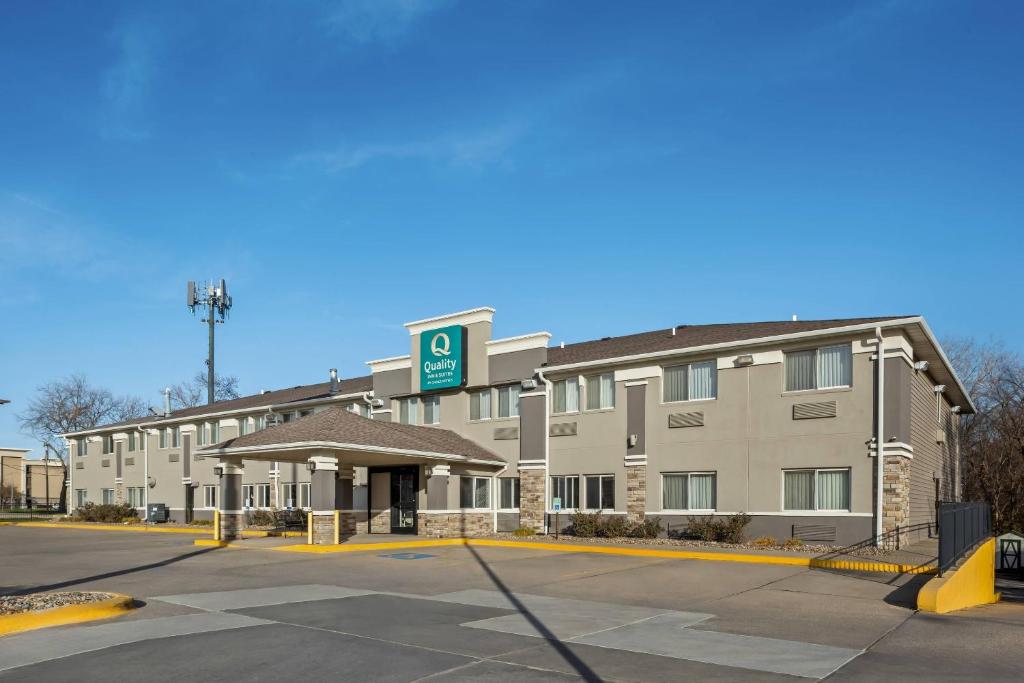 a hotel building with a parking lot in front of it at Quality Inn & Suites Des Moines Airport in Des Moines