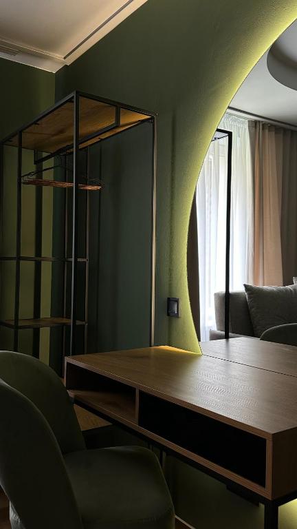 a living room with a table and a mirror at Котедж Gudz in Yaremche