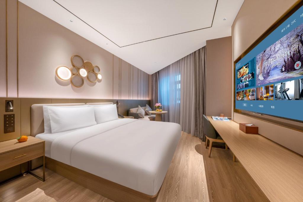 Postel nebo postele na pokoji v ubytování Orange Hotel Chengdu Shuangliu International Airport