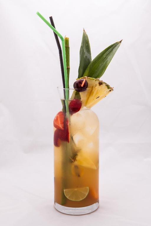 a glass vase filled with a drink with fruit at Lotus Family Hotel - Free Parking in Sunny Beach