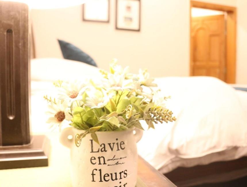 a vase with flowers in it on a table at Musketeers Resort in Dargai
