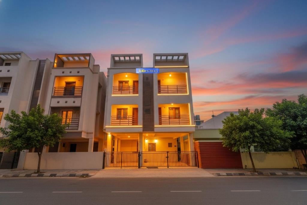 a white building with a sunset in the background at Via Blue Moon Residency in Chennai
