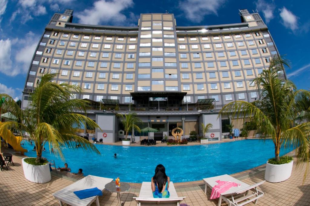 a hotel with a pool in front of it at Golden View Hotel in Nagoya