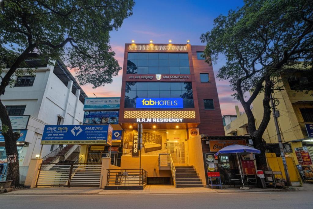 a building with a goos sign in front of it at FabHotel NRM Residency in Mysore