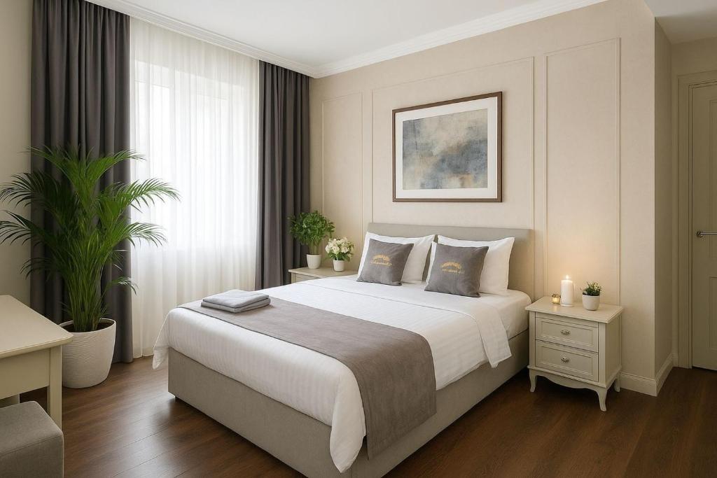 a bedroom with a large white bed and a window at Parliament Hotel & Restaurant in Baku