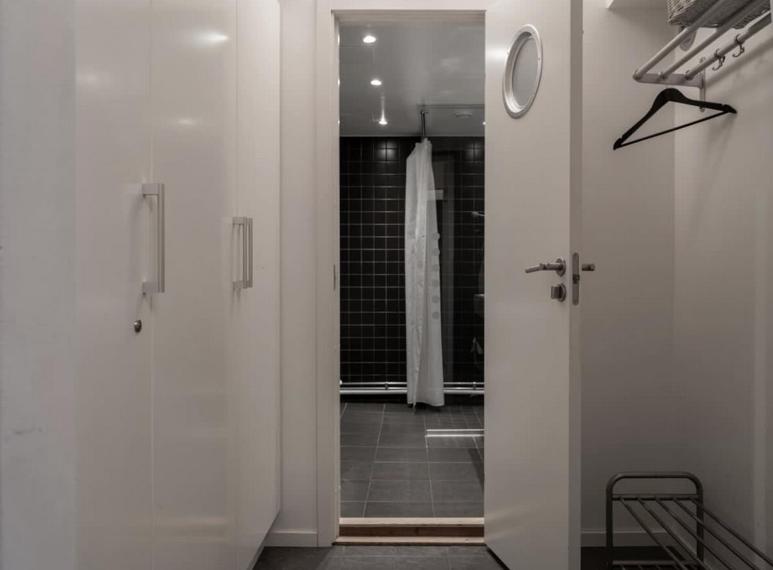 a white bathroom with a shower and a sink at Tott vacation homes in Åre
