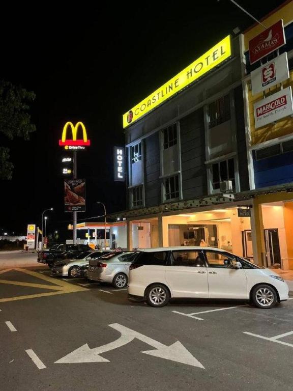 a car parked in a parking lot in front of a mcdonalds at Coastline Hotel in Port Dickson