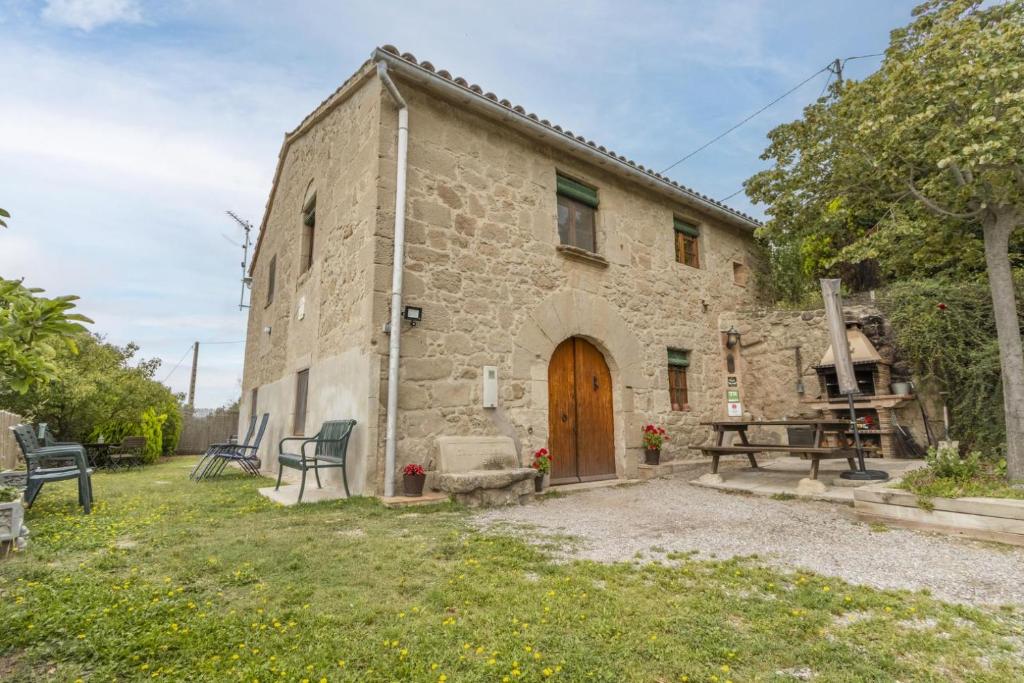 an old stone house with a wooden door at Cal Viudet Vell in Caserras