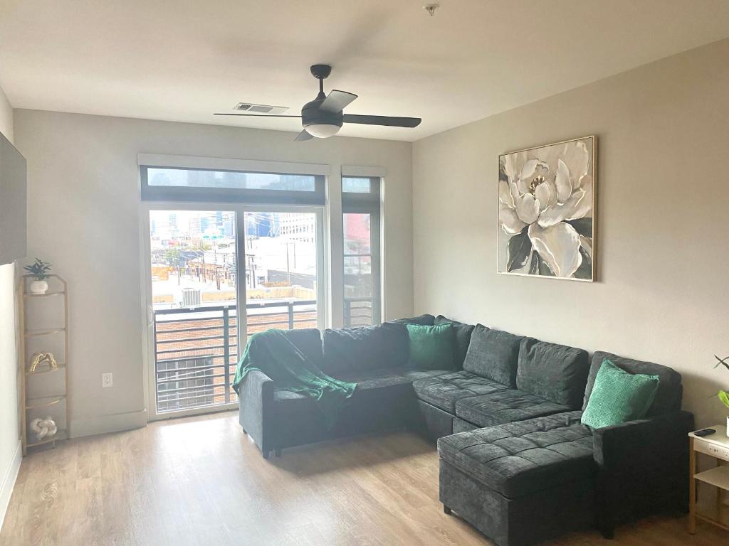 a living room with a couch and a ceiling fan at The Deep Ellum Serenity Suite in Dallas