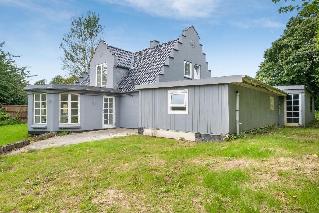 a house with a large yard in front of it at Villa Surrounded By Nature in Vissenbjerg