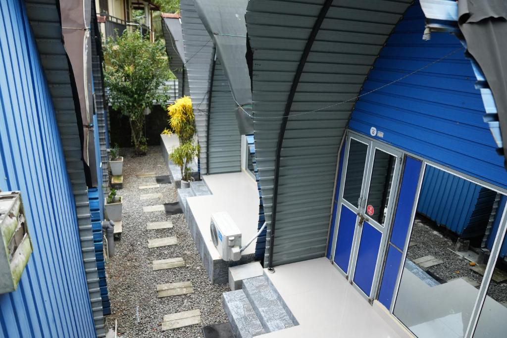 an external view of a house with a blue door at A4 Residence Colombo Airport BY A4 Transit Hub - Free luggage store & Airport Pick Up & Drop 24HRS in Katunayaka