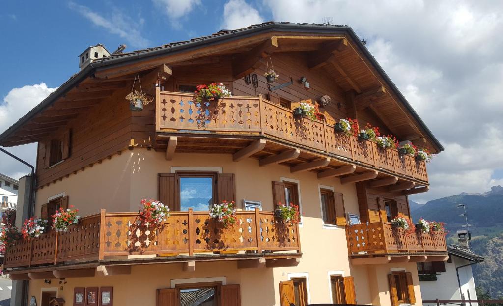 a building with a balcony with flowers on it at Maison de leon in Torgnon