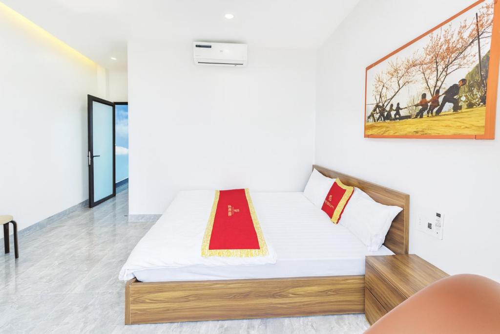 a bedroom with a bed in a room with a painting on the wall at Khách sạn Đức Phúc in Dồng Văn
