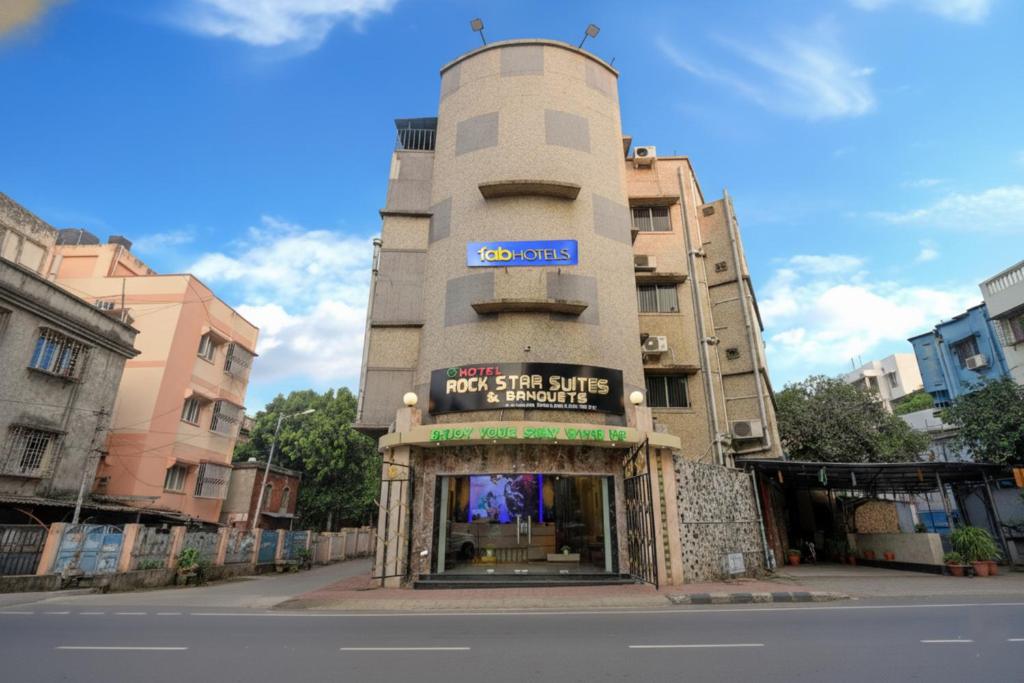 a building with a sign on the side of a street at FabHotel Prime Rockstar Suites - Nr Park Circus 7 Point in Kolkata