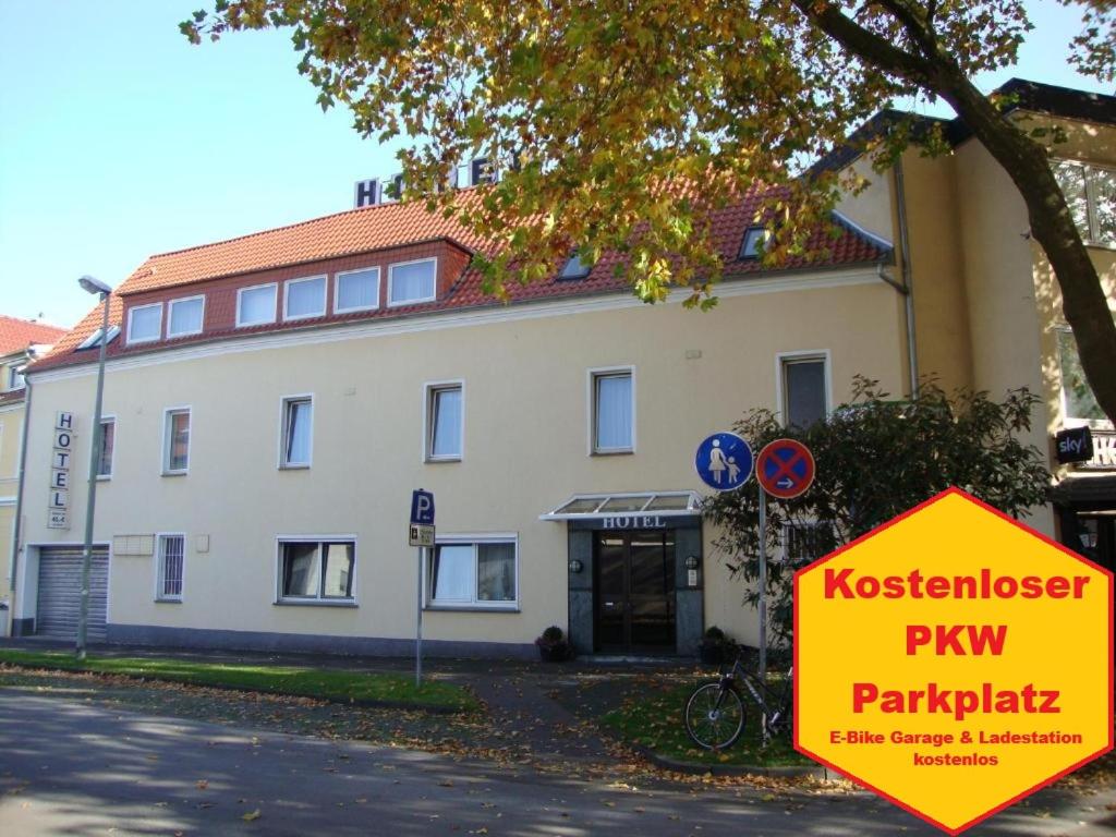 a large white building with a sign in front of it at Hotel Cherusker Hof in Paderborn