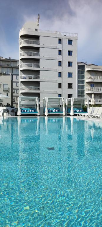 a large pool of water in front of a building at Residence Atlantico in Lido di Jesolo
