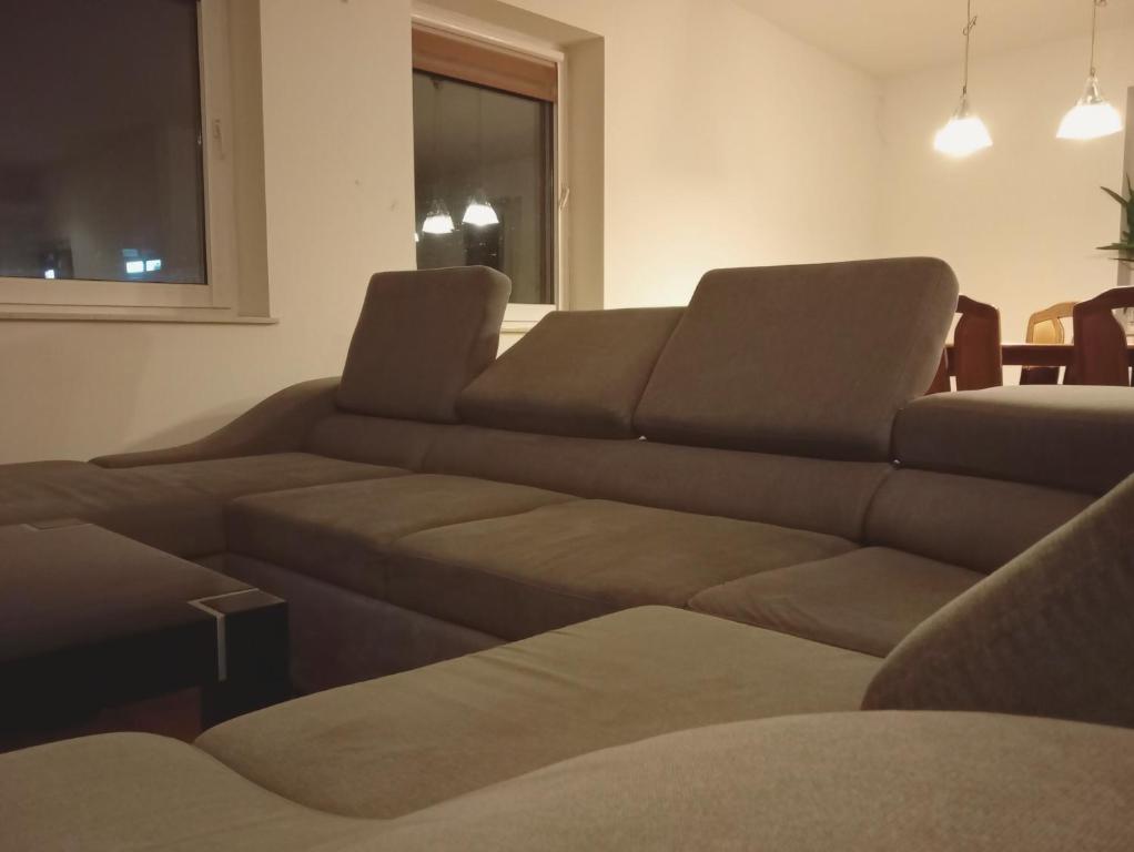 a living room with a couch and a table at Apartament z Jacuzzi in Częstochowa