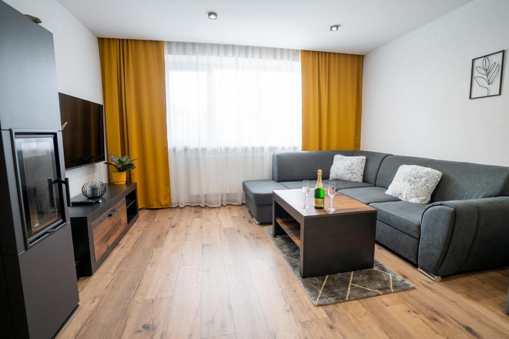 a living room with a couch and a television at Apartmany ROSTER in Liptovský Mikuláš